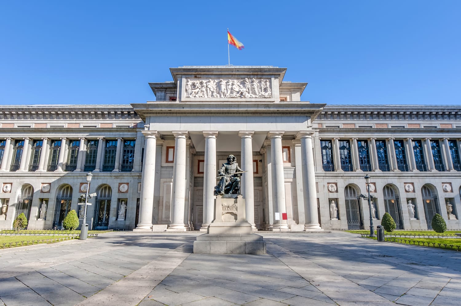 Prado Museum facade and Cervantes statue in Madrid, Spain